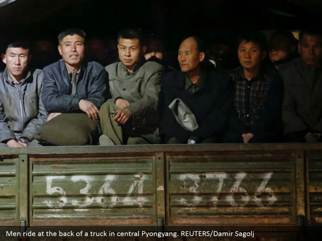 Men ride at the back of a truck in central Pyongyang. REUTERS/Damir Sagolj