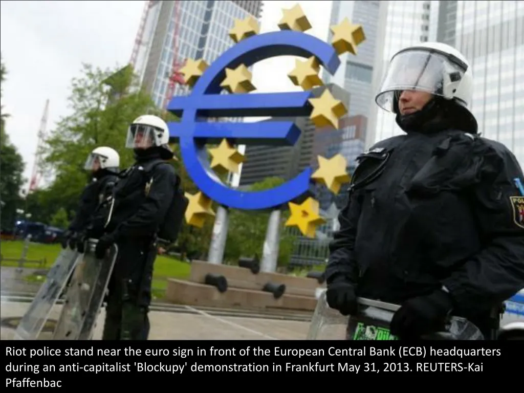 riot police stand near the euro sign in front n.